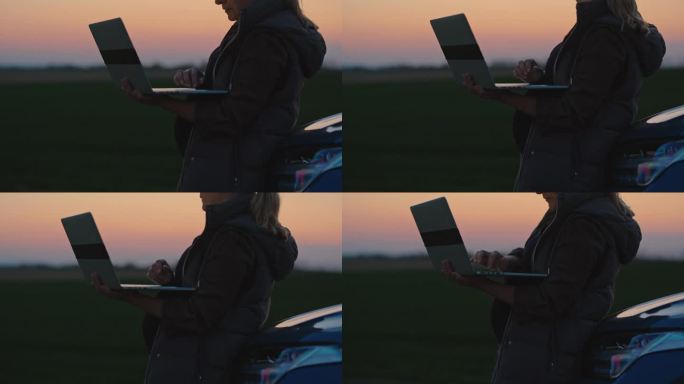 蓝色时间(Blue Hour)，孕妇在农场停车时使用笔记本电脑