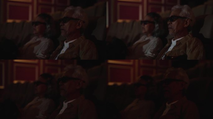 老年夫妇在电影院享受3D眼镜的电影体验。