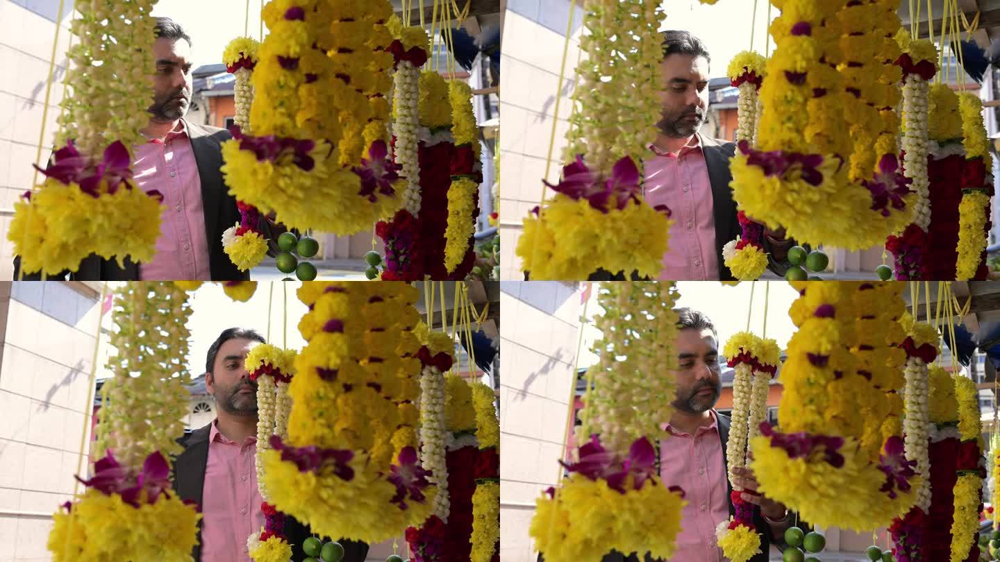 成熟的锡克教商人在花店挑选他最喜欢的花环