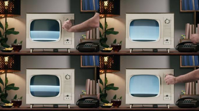 家庭背景上带有灰色干扰屏的旧电视。餐桌上复古电视的特写，复古电话，怀旧，切换频道。