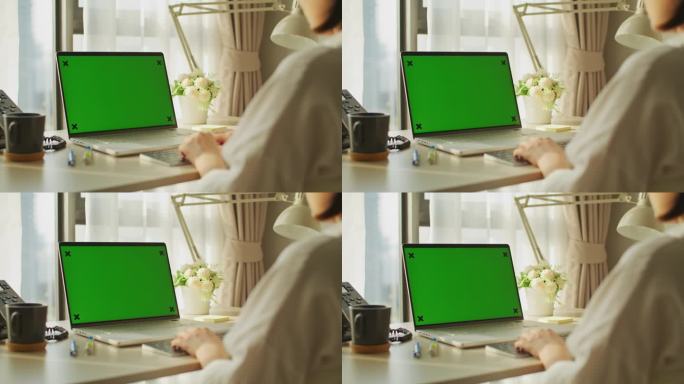 特写的年轻亚洲妇女使用笔记本电脑与模拟绿屏