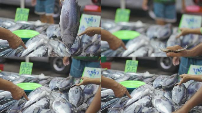 人们手工挑选和购买金枪鱼海鲜