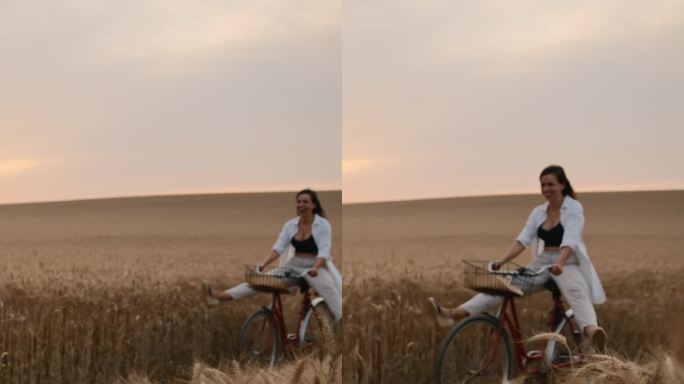 日落时分，顽皮的双腿分开的女人在麦田里骑自行车