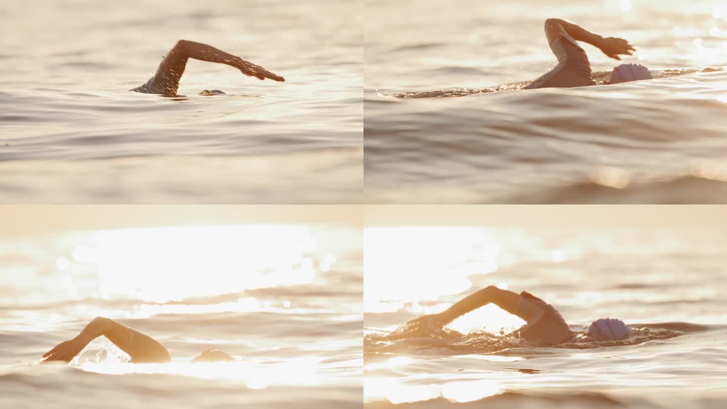 女子在日落度假期间在海洋游泳的慢镜头镜头。一个女人正在海里游泳。