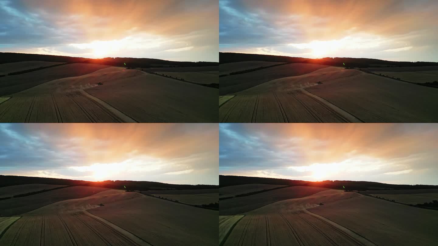 空中收获地平线:戏剧性的日落无人机画面孤独的联合收割机在金色的麦田在摩拉维亚