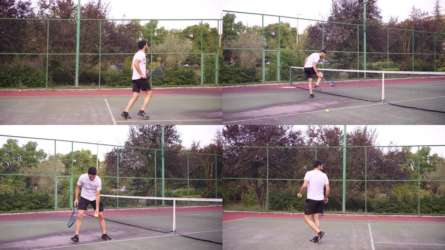 户外网球场，一个年轻人用球拍使劲击球