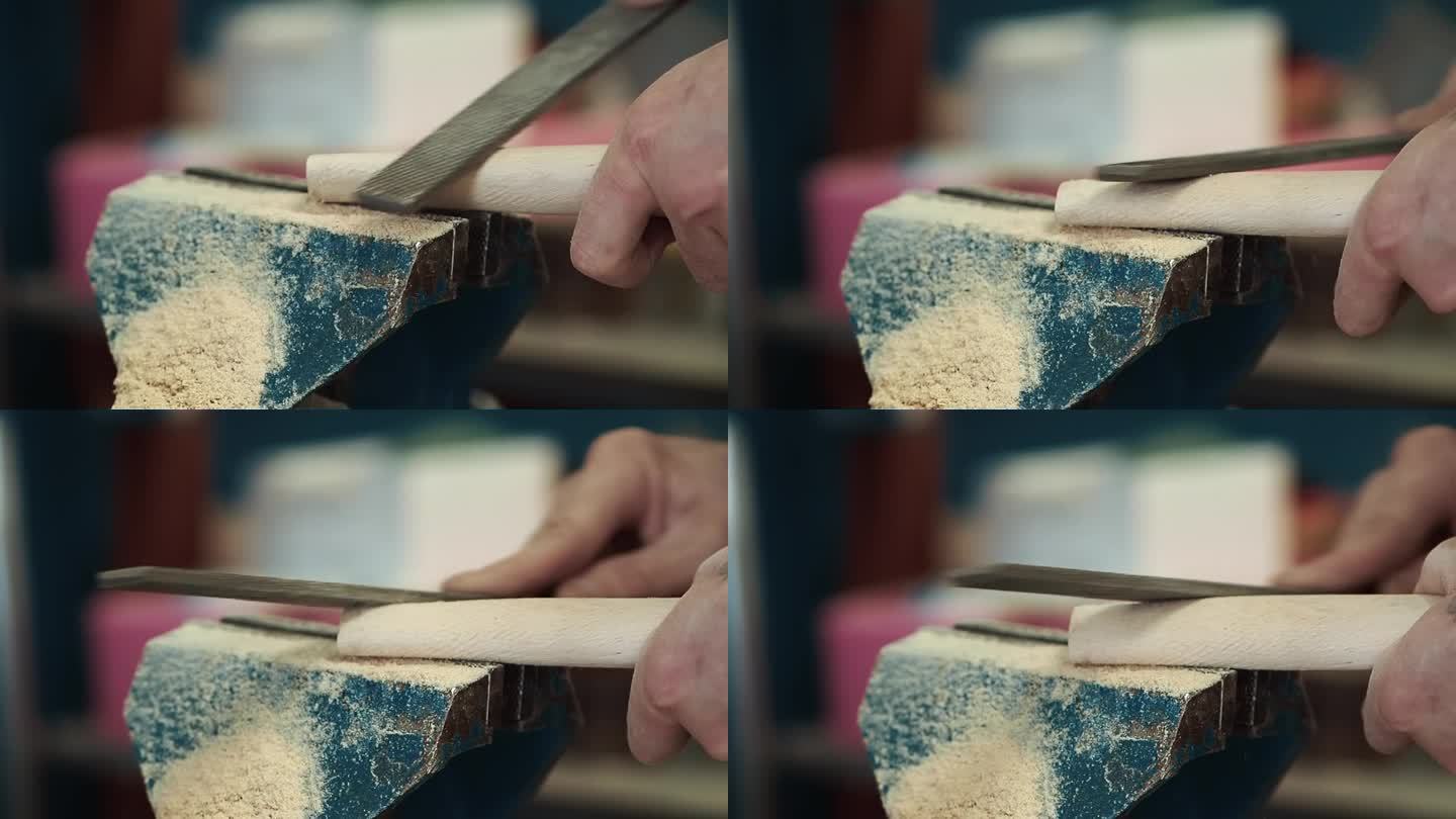 视频。木匠在工作台上用锉刀削木制品，锯末飞扬。特写镜头。
