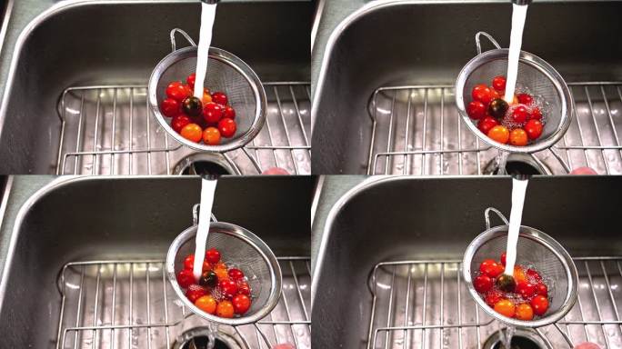 用滤网在厨房水槽里清洗新鲜的圣女果