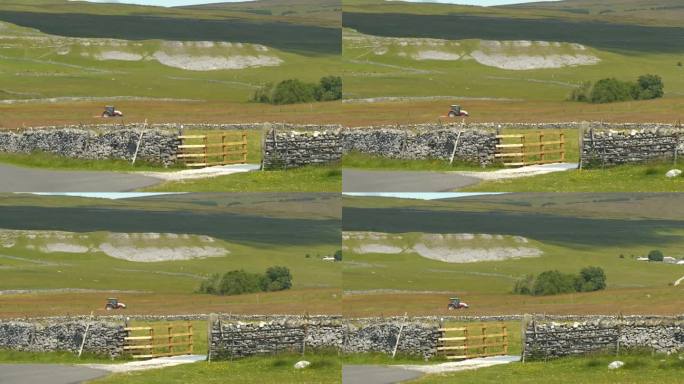 在风景秀丽的英国乡村，拖拉机在石墙草地上割草