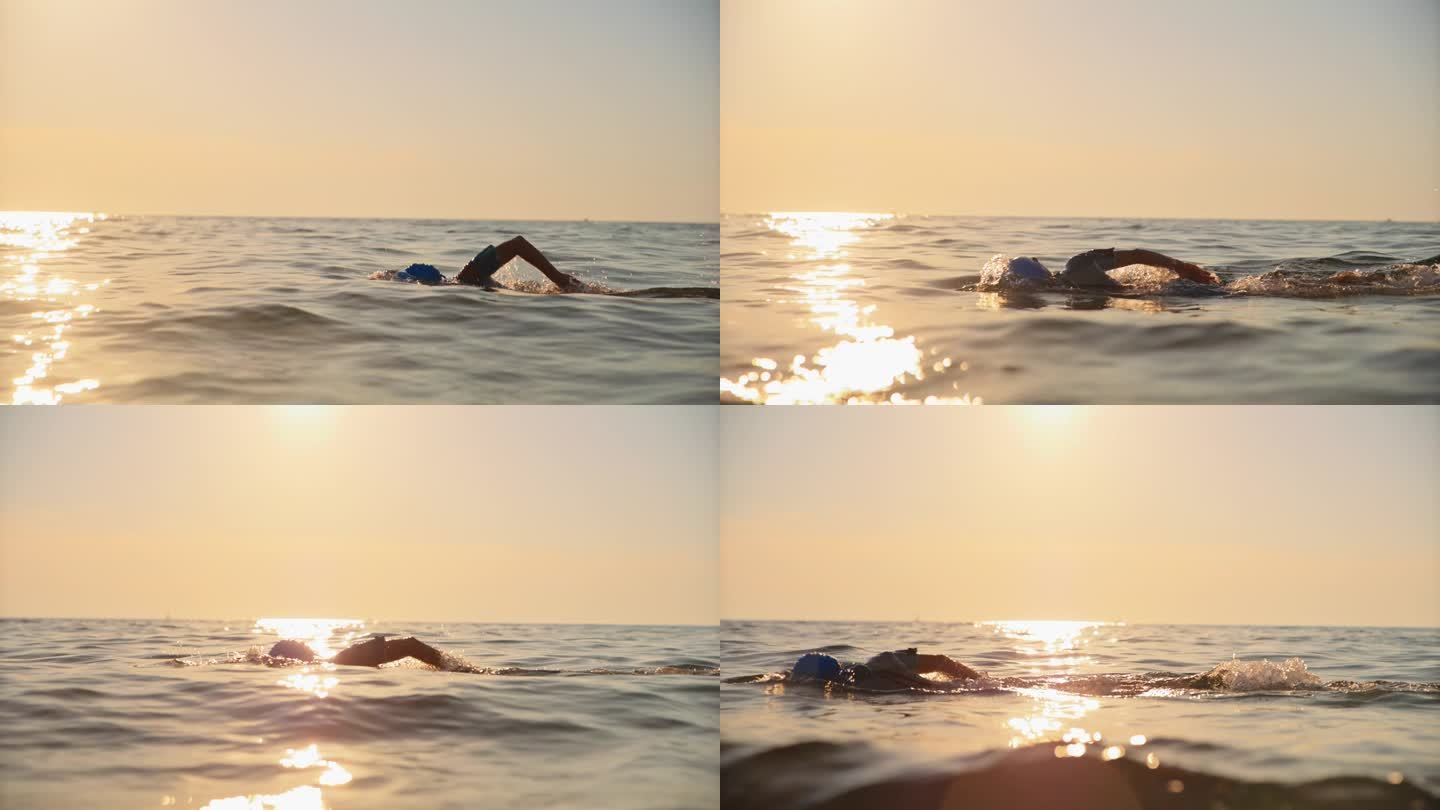女子在夕阳下度假时在海里游泳的慢镜头镜头