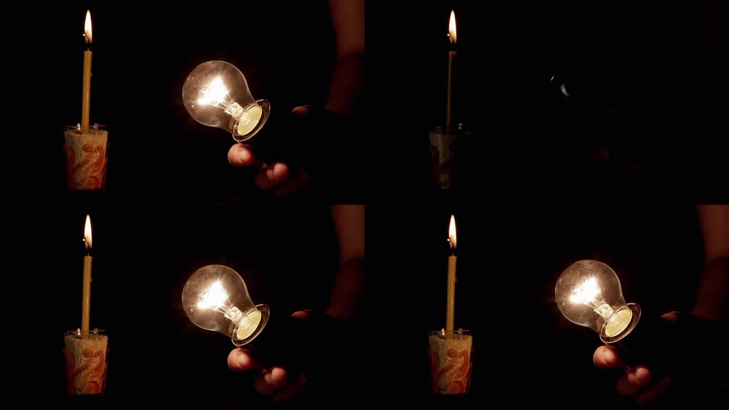 手拿一个闪烁的灯泡在黑暗的房间里，背景是燃烧的蜡烛