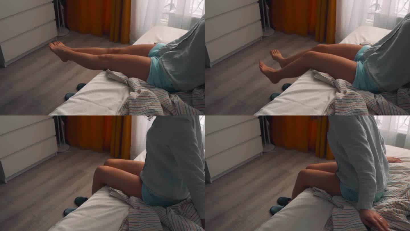 女人坐在床上，伸展着她纤细的双腿