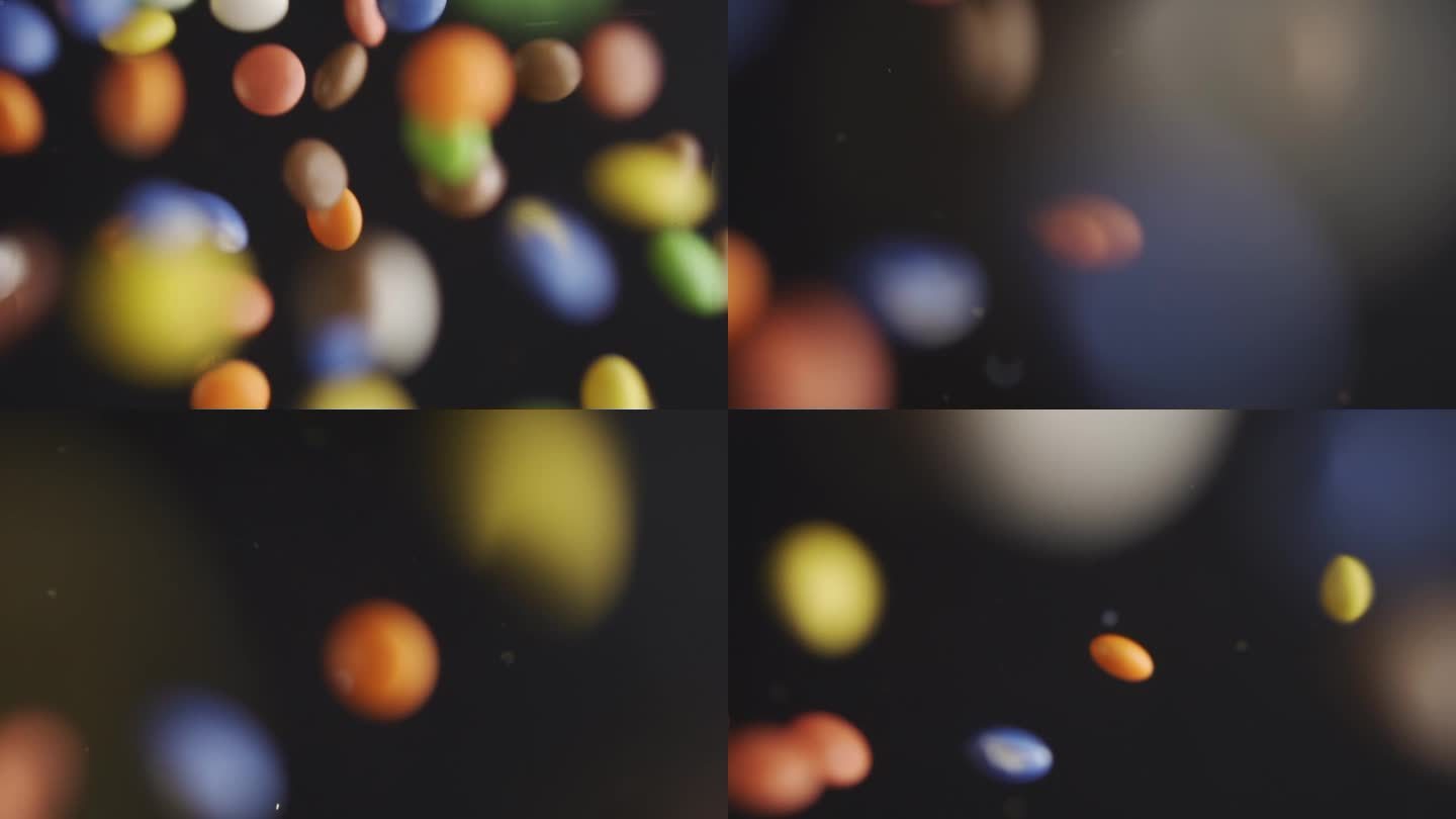 五颜六色的糖果在黑色背景上以慢动作飞行