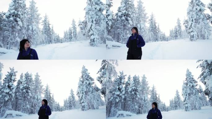 在芬兰北极圈拉普兰，一个女孩在雪景中漫步，欣赏美景和树木