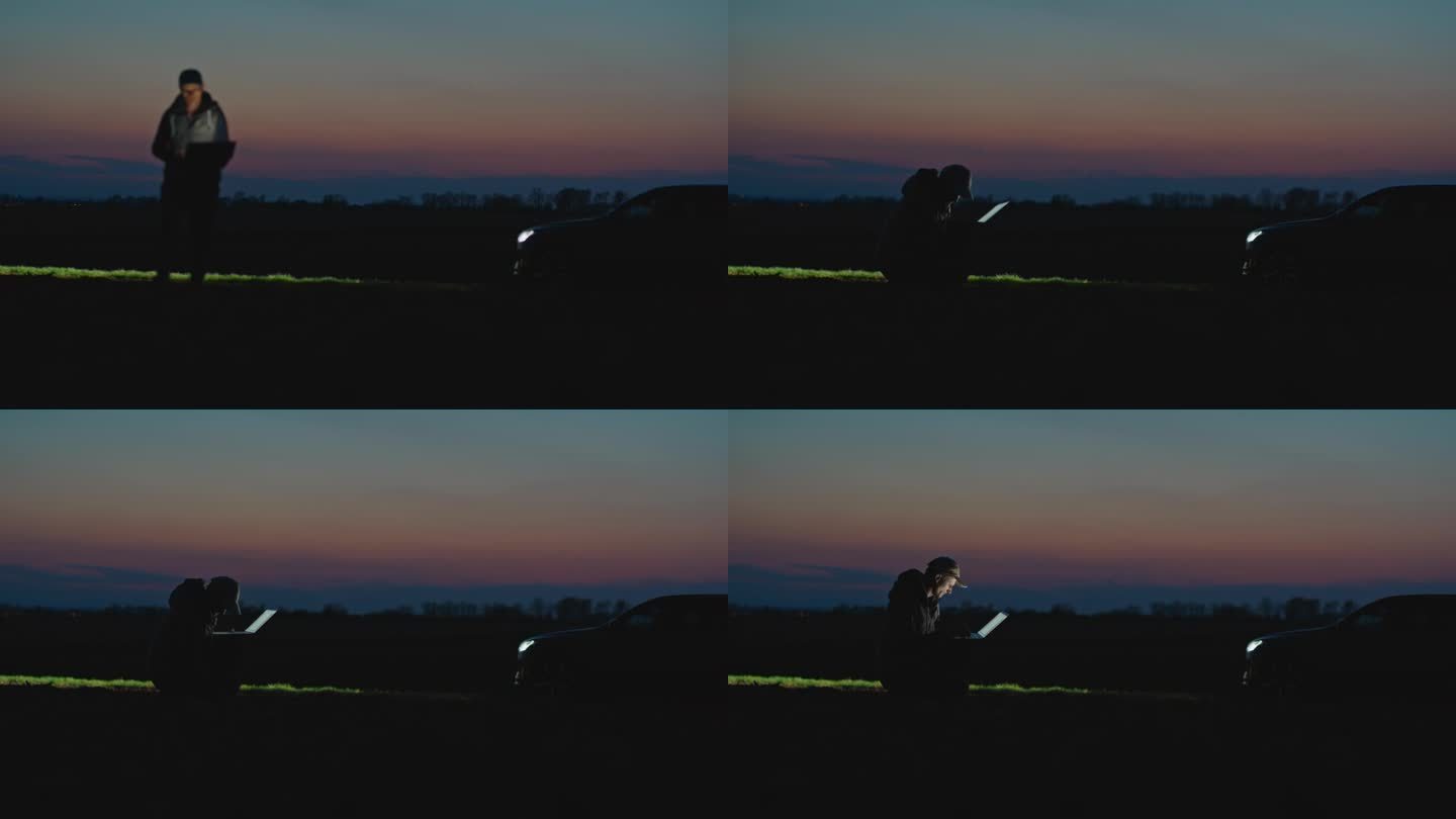 SLO MO锁定镜头的男性环保人士使用笔记本电脑和分析农场土壤在黄昏的天空