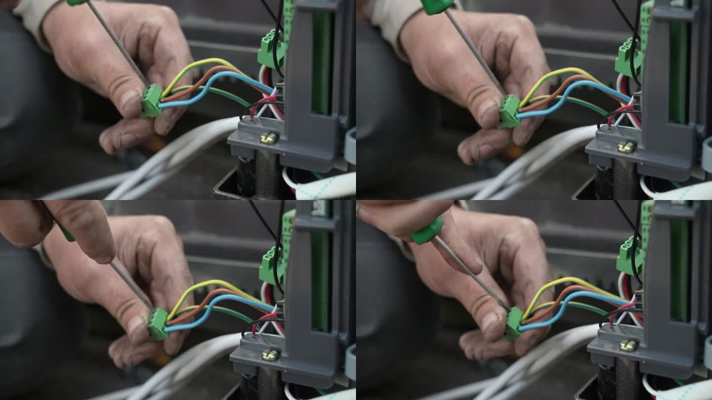 电工把电线敷设在保护波纹中。电线用波纹保护层