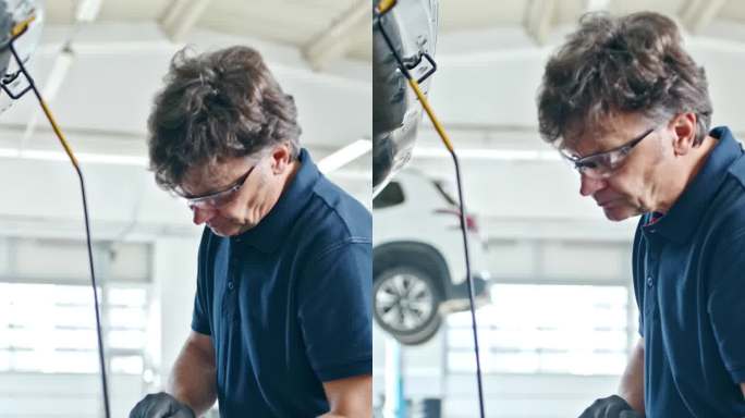 男机械师在修理厂进行汽车发动机诊断试验