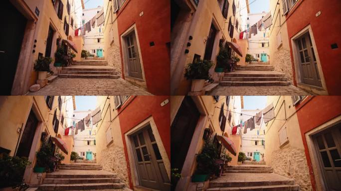 在老城区的建筑物中有台阶和晾衣绳的人行道的慢镜头镜头。古色古香的步道和石阶在房屋之间的老城景观。在质