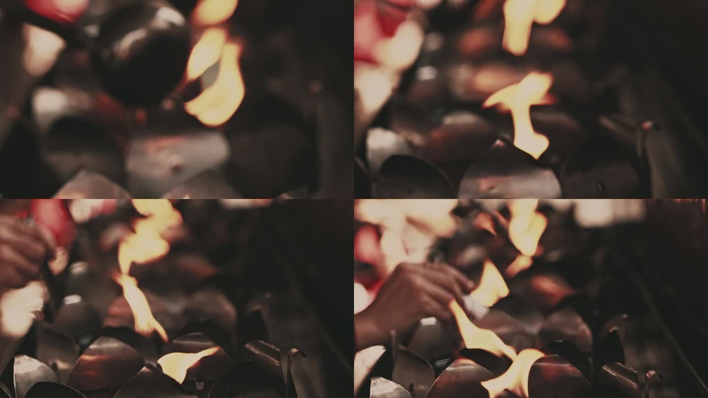 人手舀油灯对蜡烛的特写