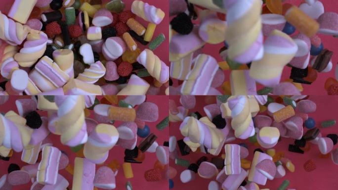 五颜六色的糖果，包括棉花糖，扔在空中，在超级慢动作1000帧/秒的微缩