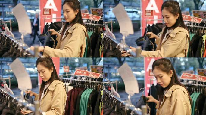 年轻的Z世代日本女性在日本涩谷折扣店购买服装