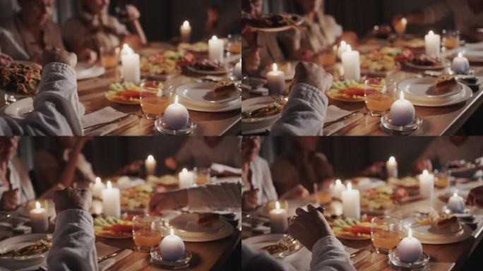 为了庆祝感恩节，一个大家庭吃了一顿节日晚餐，他们坐在节日的餐桌旁，享用美味的食物