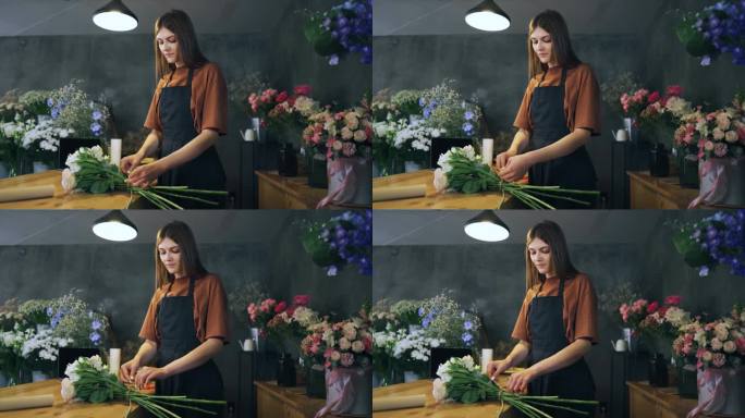 一个花店为她店里的活动安排了令人惊叹的植物。这个女孩满怀爱意地把鲜花捆在一起，用充满春天气息的鲜花让
