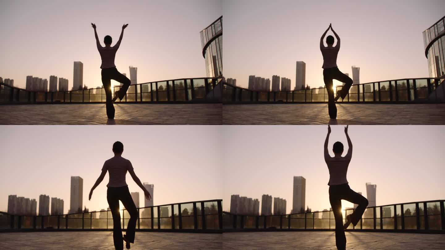 阿莱拍摄城市夕阳下女人做瑜伽健身运动放松