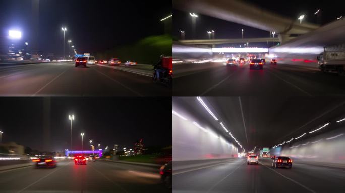 夜晚照亮阿布扎比到迪拜公路之旅交通高速公路前全景4k延时阿联酋