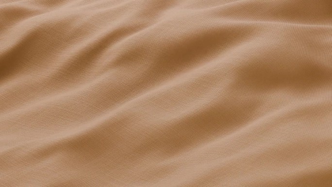 特写波浪橙色丝绸面料飘动表面与织物细节