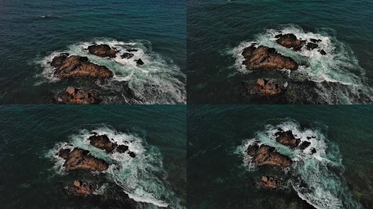 尖锐的石头被海沫包围，鸟瞰。加那利群岛