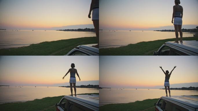 日落时站在海边露营车上的悠闲女子的慢镜头镜头