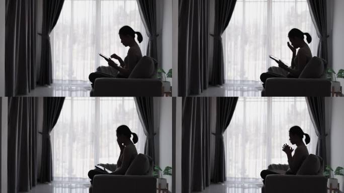 忧郁的女人坐在卧室的剪影被健康问题困扰，压力累积关系问题。