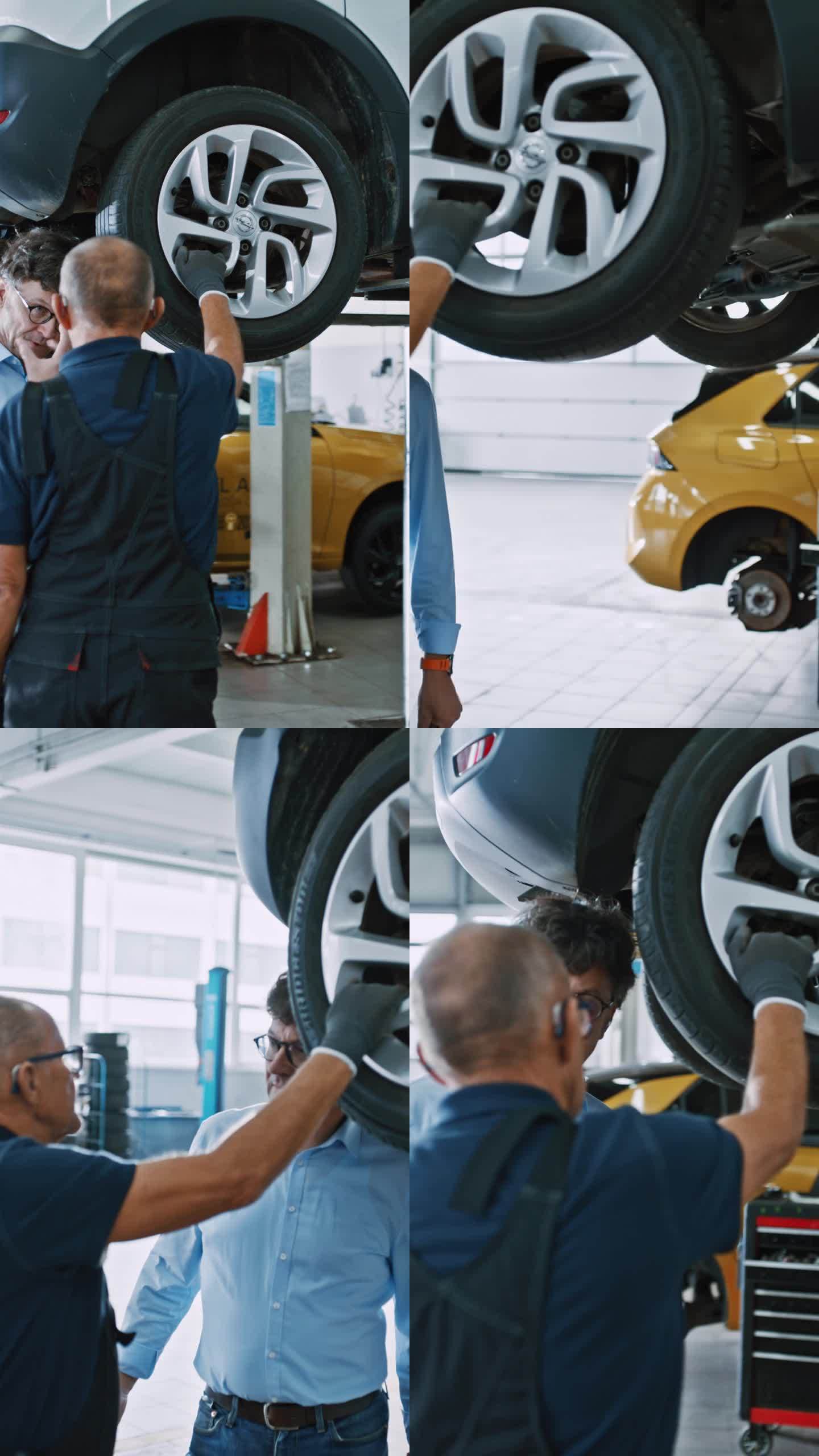男经理和机械师在修理厂讨论汽车轮胎修理