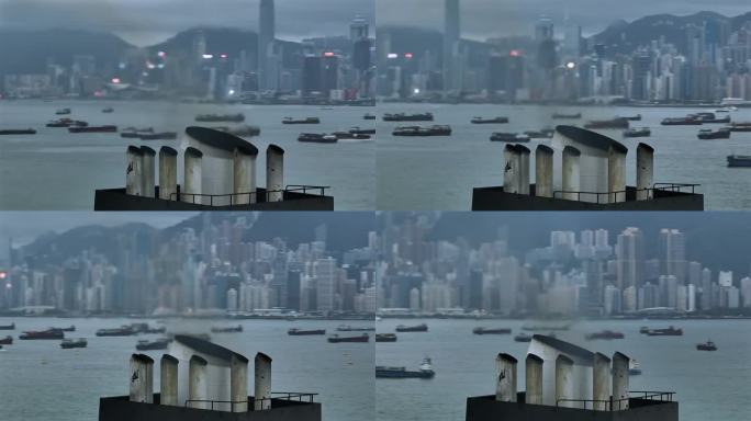从货船的烟囱中喷出的热烟。视差无人机拍摄的香港天际线为背景