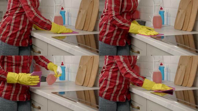 女性用清洁剂清洗厨房台面油污的特写镜头
