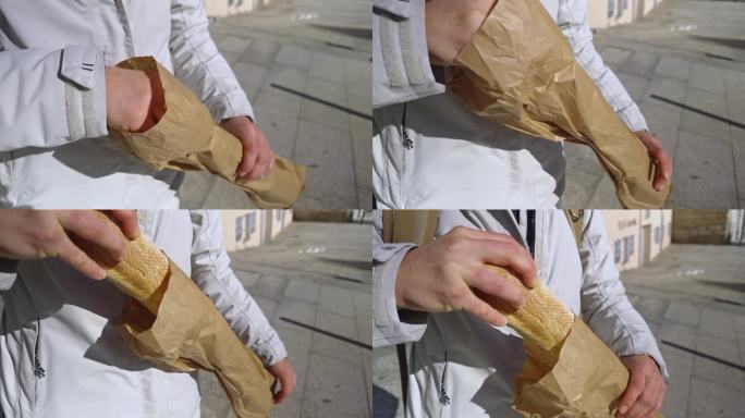 城市小吃:在城市街道上从纸袋里抢来的新鲜面包