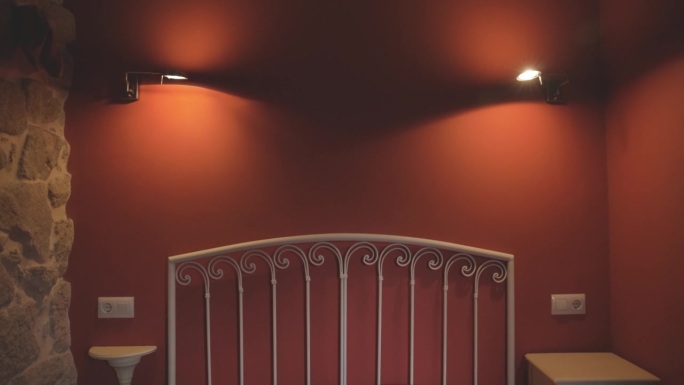 带灯的红色空卧室和金属床