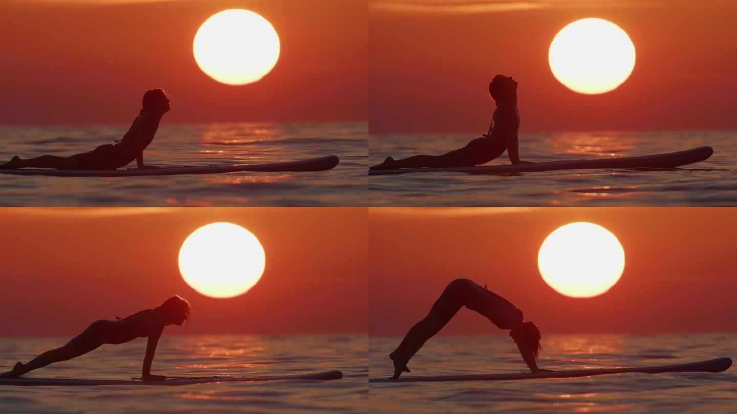 日落时在海上冲浪板上运动的女性的慢镜头镜头