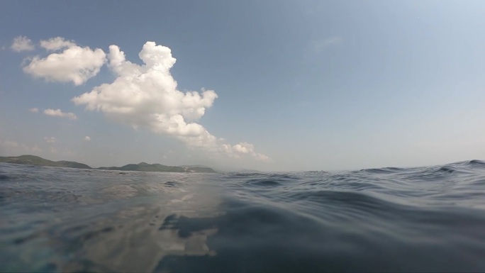 夏季室外游泳池的水波面，天空中有云的运动场景