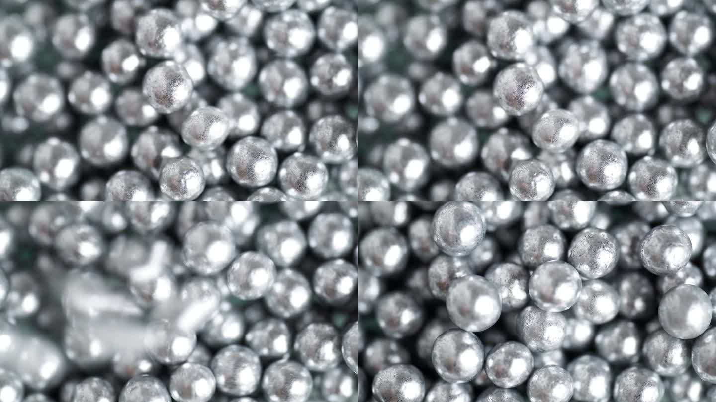 落下和滚动的银球与其他许多球的背景表面。珠宝银质珍珠珠。银球旋转