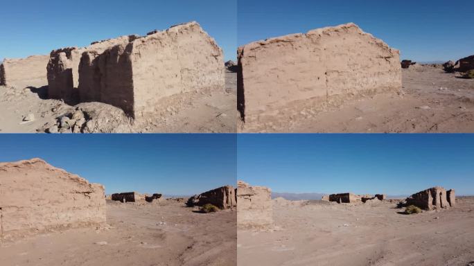 破败的泥砖土坯建筑在干燥的沙漠景观与清澈的蓝天没有云