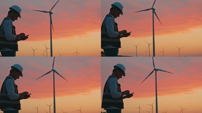 日落时分，SLO MO工程师在乡下的智能手机上检查风力涡轮机的运行数据