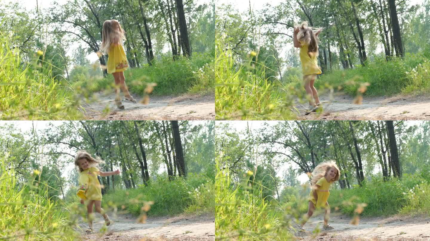 快乐的小女孩，金色的长发，穿着黄色的裙子，沿着草地上的小路奔跑，夕阳西下