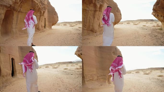 沙特阿拉伯人走在岩石雕刻的坟墓之间的沙漠