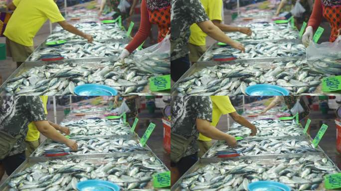 人们手工挑选和购买金枪鱼海鲜