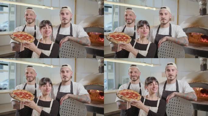 Team of Bakers Posing Together on Camera in Pizzer