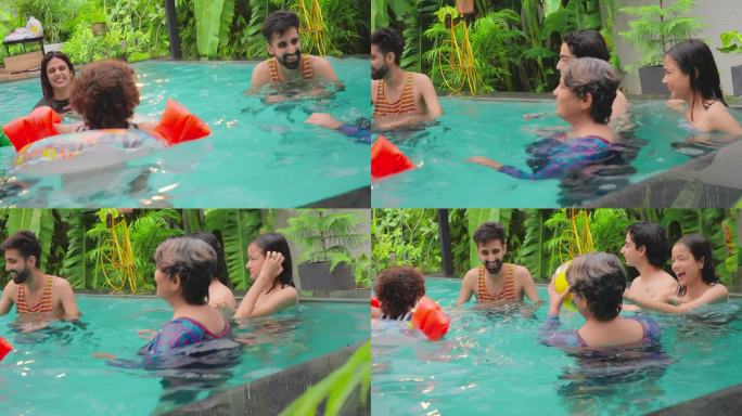快乐的印度朋友在游泳池里手拉手围成圈，一起在户外水上乐园度假。微笑的大龄中年祖父母兄弟姐妹度假屋酒店