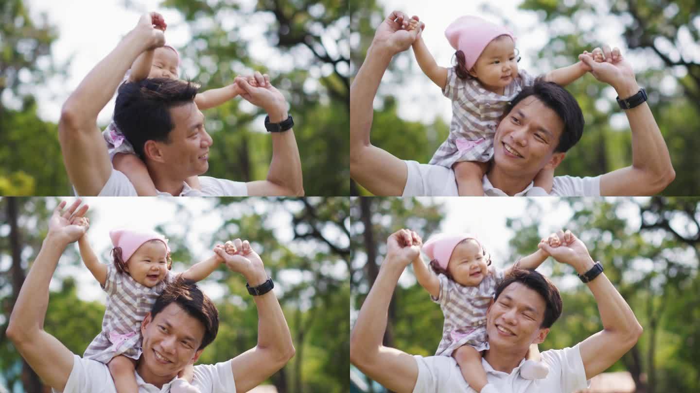 父亲和他的女孩，亚洲女婴骑在父亲的脖子上