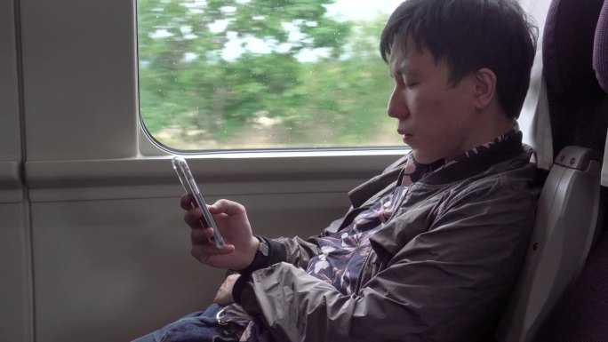 一名男子在火车上使用手机